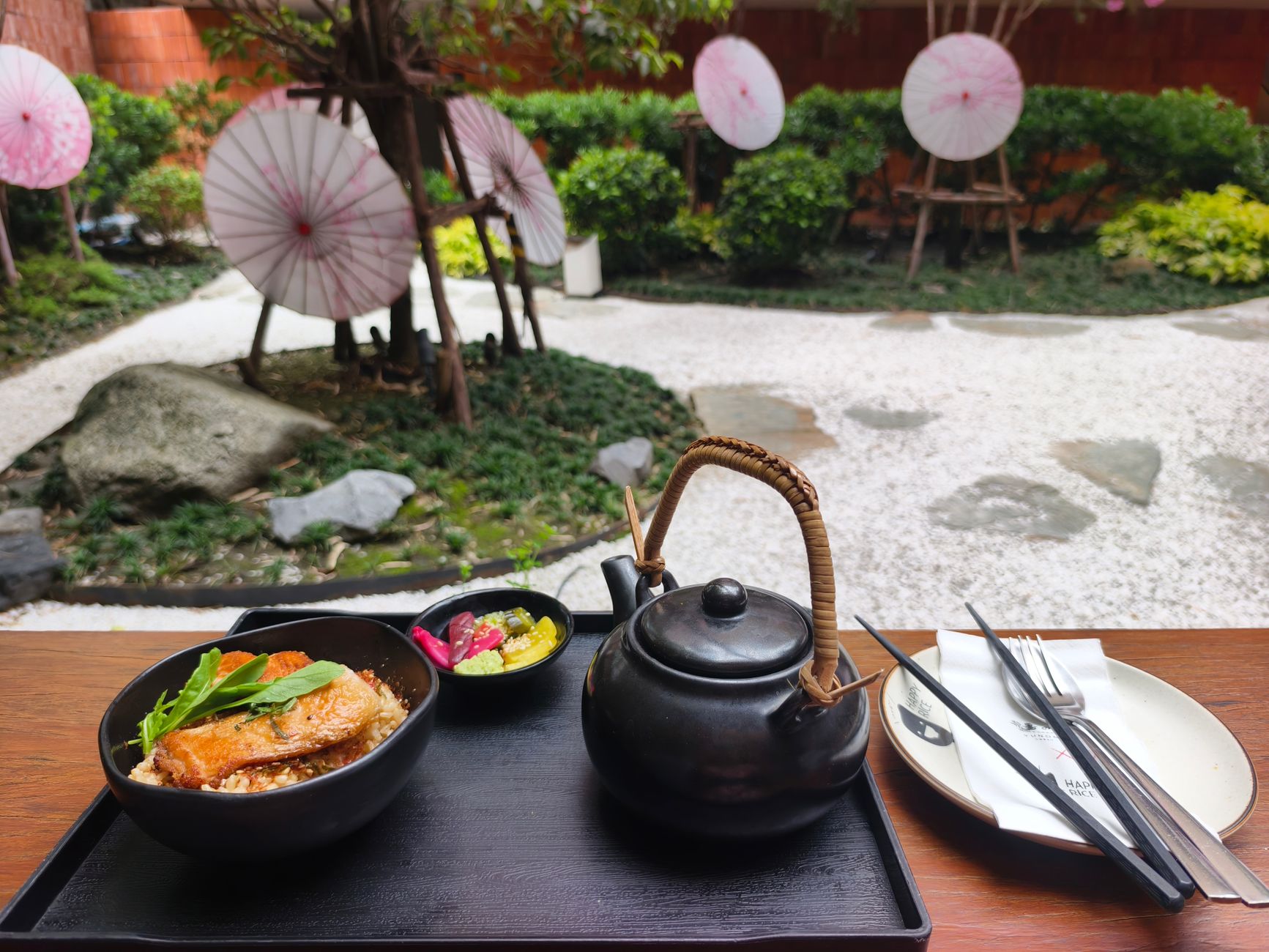 Artisanal ceramic tableware with steaming tea and seasonal ingredients
